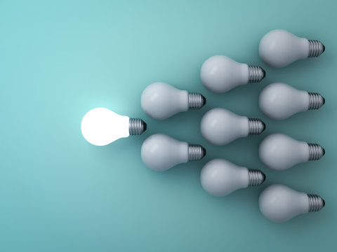 One glowing light bulb standing out from the unlit incandescent bulbs on green background , leadership and different concept . 3D rendering.