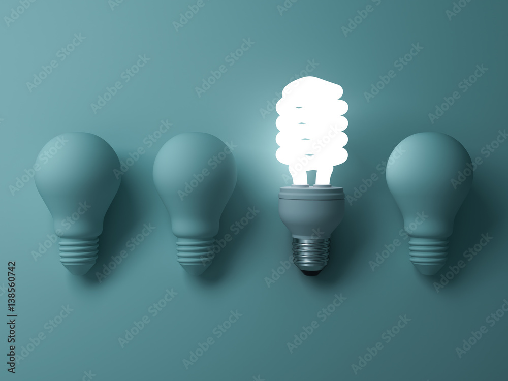 Poster eco energy saving light bulb , one glowing fluorescent lightbulb standing out from unlit incandescen