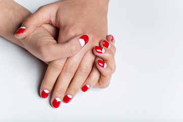 Female hands with red and white nails