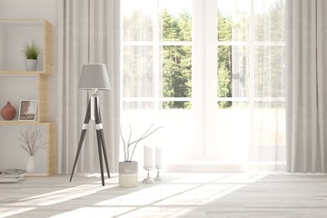 White room with lamp and green landscape in window. Scandinavian interior design