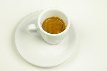 White porcelain cup of espresso coffee on a white background
