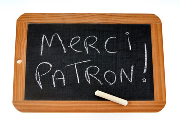 Obraz premium Merci patron écrit sur une ardoise