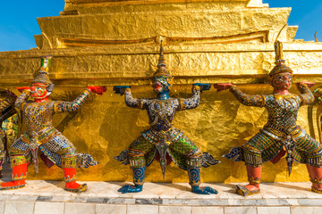 Golden pagoda with giant statue at Royal grand palace temple