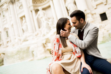 tourist couple on travel by Trevi Fountain in Rome, Italy.