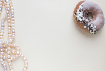 Blank craft background. Sheet of rough paper with rose pearls and donut. Mock up for letter writing, creative work concept