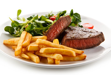 Grilled steak, French fries and vegetables 