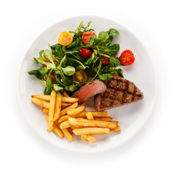 Grilled steak, French fries and vegetables 