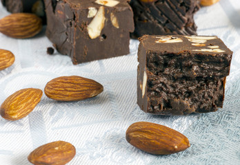 Homemade nut fudge with almond on light cloth napkin