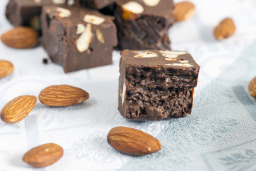 Homemade nut fudge with almond on light cloth napkin