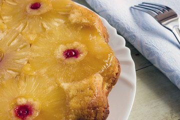 Homemade pineapple upside down cake on black background