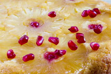 Homemade pineapple upside down cake on black background