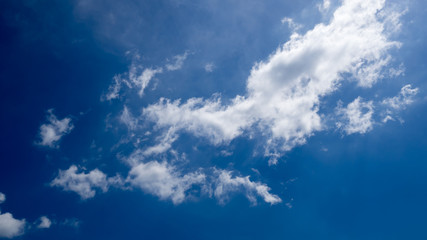 Naklejka na ściany i meble Clear blue sky background with tinny clouds.