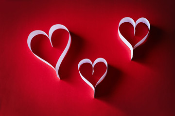 Paper hearts on a red background