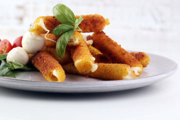 Breaded mozzarella cheese sticks with tomato ketchup and bbq sauce