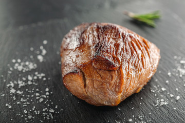 grilled steak with rosemary on a  wooden background