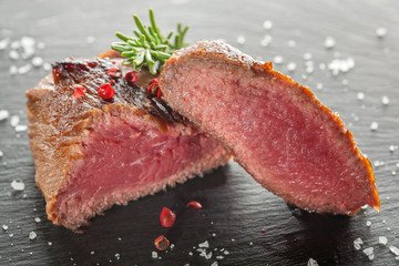 grilled steak with rosemary on a  wooden background