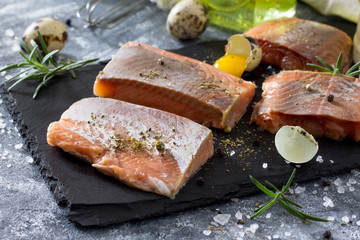 Ingredients for cooking egg omelet stuffed with red fish fillet. The concept of healthy nutrition and diet. Easy cooking breakfast on a concrete background.