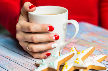 Woman holding a cup with tea