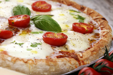 Hot true PEPPERONI ITALIAN PIZZA with salami and cheese. TOP VIEW Tasty traditional pepperoni pizza on board on wooden table with decoration