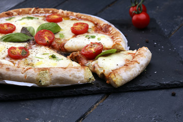 Hot true PEPPERONI ITALIAN PIZZA with salami and cheese. TOP VIEW Tasty traditional pepperoni pizza on board on wooden table with decoration