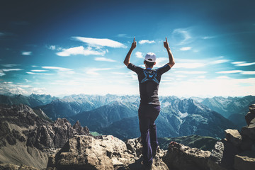 Mountaineer celebrating reaching the summit