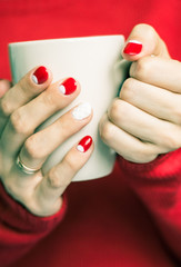 Woman holding a cup with tea