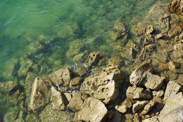 stones sea water green