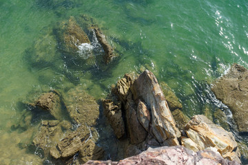 stones sea water green