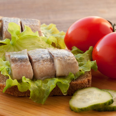 sandwich with herring, tomatoes and cucumber