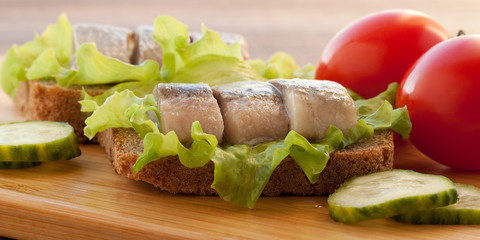 sandwich with herring, tomatoes and cucumber