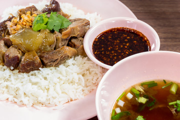 Thailand style rice braised pork and soup on wooded backgound