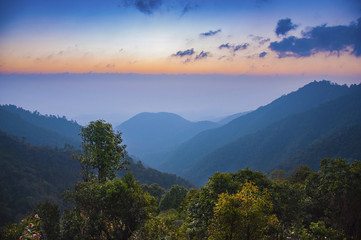 View of mountains, autumn landscape with foggy hills at sunrise