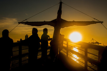 Fototapeta na wymiar Adventure traveling by silhouette cruise ship at sunset