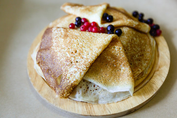 delicious pancakes on wooden table with orange and orange juice