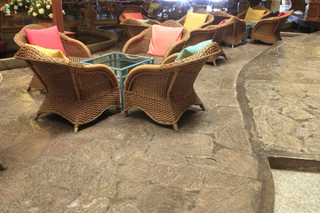 rattan chair with backrest pillow and glass table in reception hall for relax or lunch and dinner...