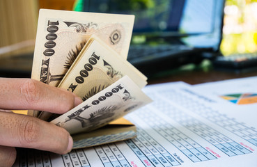 Woman is counting money with statement paper financial concept.