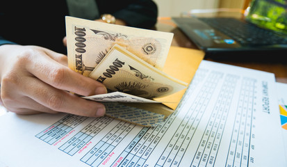 Obraz premium Woman is counting money with statement paper financial concept.