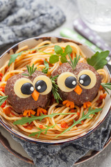 Pasta spaghetti with funny meatballs for kids
