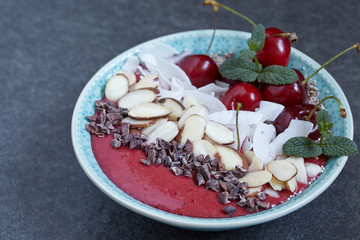 Smoothie bowl with cherry, coconut, almond and chia seeds