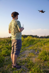 Father and son controls RC drone in the sky