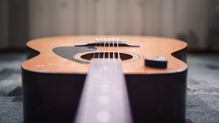 Acoustic Guitar with very shallow depth of field, focus on strings. Interesting color isolation...