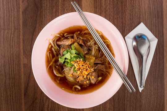 Thailand style Noodles braised pork soup on wooded