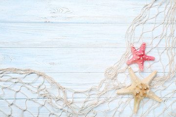 Fishing net with starfish on wooden table