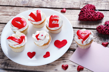Tasty cupcakes on a brown wooden table