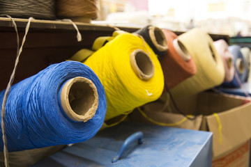 threads for sewing, on bobbins of different colors