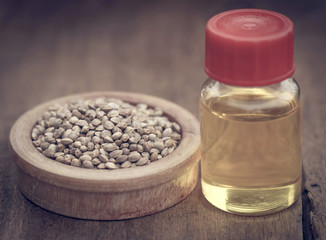 Seeds of Cannabis or hemp with essential oil in bottle