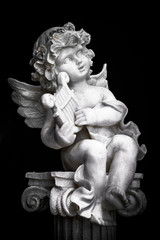 Statue of Little Cupid playing harp in black and white