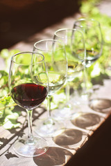 Wine glasses on on sunny outdoor table