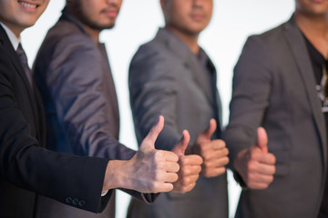 Fototapeta premium Hands of business people showing thumbs up