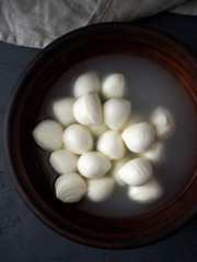 Healthy homemade fresh mozzarella cheese in bowl top view 